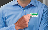 person wearing an expiring screened sticker